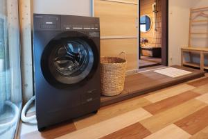 a washer and dryer in a room at 御宿 凪ぐ Takayama in Takayama