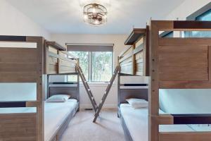 a room with three bunk beds and a chandelier at Flat Tops 2510 in Steamboat Springs +43 photos