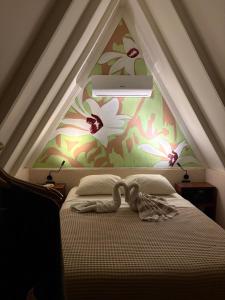 a bedroom with a bed with a flower wall at Casa Balam Holbox, Beach style cabañas in Holbox Island