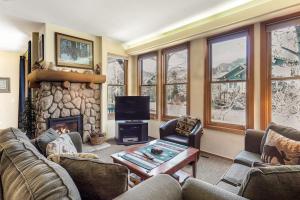 a living room with a couch and a fireplace at Snowcreek 847 in Mammoth Lakes