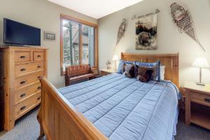 a bedroom with a large bed and a television at Snowcreek 847 in Mammoth Lakes +71 photos