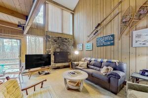 a living room with a couch and a tv at North Conway Condo in North Conway