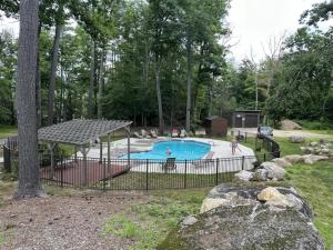 aenced in swimming pool in a yard with people around it at North Conway Condo in North Conway
