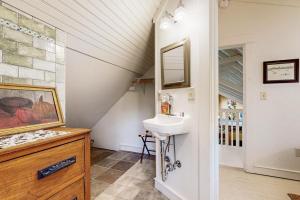 a bathroom with a sink and a mirror at Lakeside Elegance in Tyson +91 photos