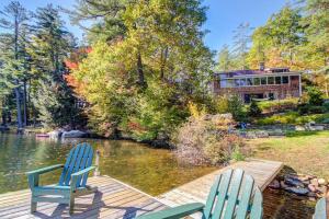 two blue chairs sitting on a dock next to a lake at Lakeside Elegance in Tyson