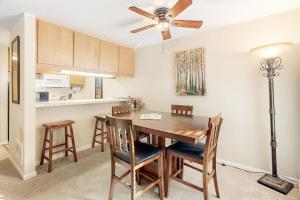 a kitchen with a dining room table and a ceiling fan at The Summit 207 in Old Mammoth