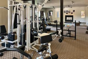 a gym with several treadmills and machines at The Summit 207 in Old Mammoth