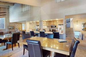 a dining room and kitchen with a table and chairs at Chamonix 100 in Mammoth Lakes