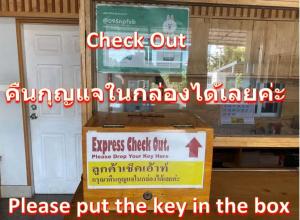 a sign on the window of a shop with a key in the box at Lee Place Phatthanakan Condo in Bangkok