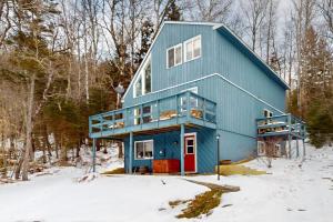 a blue house in the woods in the snow at West Dover Getaway in West Dover