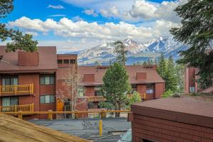 a view of snow capped mountains from a building at Mammoth Ski & Racquet 124 in Mammoth Lakes