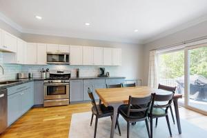 a kitchen with a wooden table and chairs at Woodlands At Loon in Lincoln