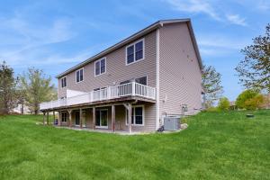 a large house on top of a green field at Woodlands At Loon in Lincoln
