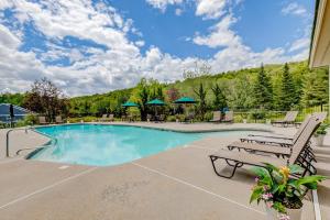 a swimming pool with two chairs and a bench at Woodlands At Loon in Lincoln