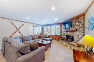 a living room with a couch and a fireplace at Mountainback 35 in Mammoth Lakes