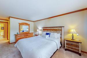 a bedroom with a large white bed and a mirror at Mountainback 35 in Mammoth Lakes +84 photos