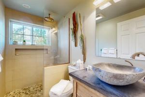 a bathroom with a large stone sink and a shower at Magnolia Tides in Gloucester +48 photos