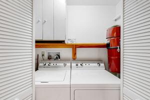 a kitchen with white cabinets and a stove at Forest Hideaway in Waterville Valley +49 photos