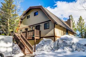 a house with a deck in the snow at Mammoth View Villas 30 in Mammoth Lakes