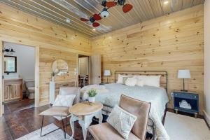 a bedroom with a bed and a wooden wall at Valley Vista Vacay in Littleton
