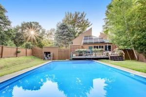 a swimming pool in front of a house at Sugar Run 34 in Sugarbush Village