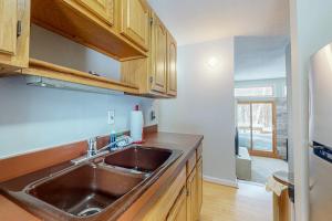 a kitchen with a sink and wooden cabinets at Sugar Run 34 in Sugarbush Village