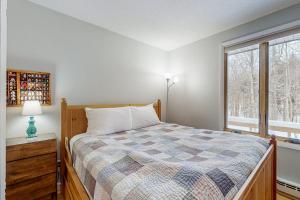 a bedroom with a bed and a window at Sugar Run 34 in Sugarbush Village +45 photos
