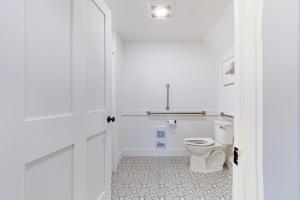 a white bathroom with a toilet and a sink at Bayberry Farmhouse in Weston +46 photos