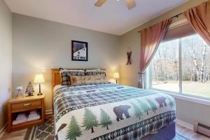 a bedroom with a bed and a large window at Snow Mountain Village 13F in Dover +58 photos
