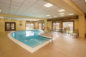 a large swimming pool in a room with a table and chairs at Snow Mountain Village 13F in Dover
