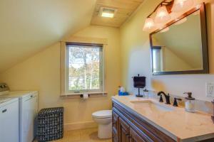 a bathroom with a sink and a toilet and a mirror at North End Nook in North Hero +40 photos