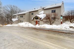 a building with snow on the side of a road at Snow Tree 337H in Dover