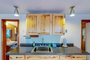 a kitchen with a sink and wooden cabinets at Garden Island's Oak in Charlotte +44 photos
