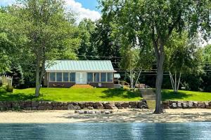 a house on the shore of a body of water at Thayer Beach Lakehouse in Colchester