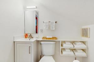 a white bathroom with a toilet and a sink at North Country 6 in Proctorsville +23 photos