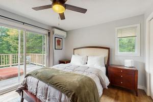 a bedroom with a bed and a ceiling fan at Ski Dreams in Dover