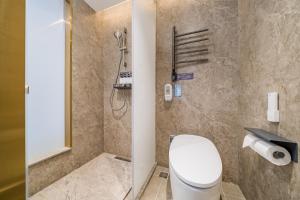 a bathroom with a toilet and a shower at Nostalgia S Hotel Beijing Guomao in Beijing