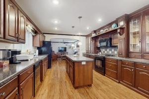 a large kitchen with wooden cabinets and wooden floors at Stargazing Daydreamer in Arlington