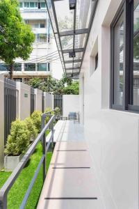 an internal courtyard of a building with benches and plants at Tiva Residence Bangkok in Bangkok