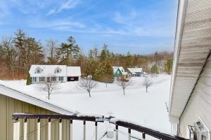 a view of a snow covered yard from a house at Stargazing Daydreamer in Arlington