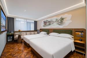 a hotel room with two beds and a television at Nostalgia S Hotel Beijing Guomao in Beijing +111 photos