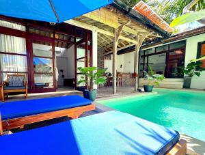 a villa with a swimming pool and a house at Villa Bambu - 2BR Pool Villa in Central Bukit Uluwatu in Uluwatu