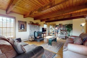 a living room with couches and a fireplace at Green Mountain Sunrise in Dover