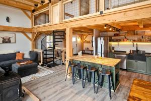 a large kitchen and living room with a wooden ceiling at Timber Riverhouse in Readsboro +112 photos