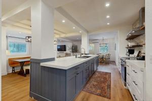 a large kitchen with a large island in the middle at Mill Brook Retreat - Unit 1 in Waitsfield