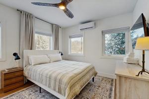 a bedroom with a bed and a ceiling fan at Mill Brook Retreat - Unit 1 in Waitsfield
