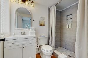 a white bathroom with a toilet and a shower at Mill Brook Retreat - Unit 1 in Waitsfield +51 photos