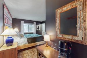 a bedroom with a bed and a large mirror at 5B Mountain Village- Unit B in Dover