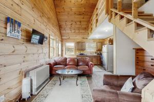 a living room with a couch and a table at Brook Haven Cabin in Jeffersonville