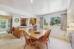 a kitchen and dining room with a table and chairs at South Village #8 in Warren